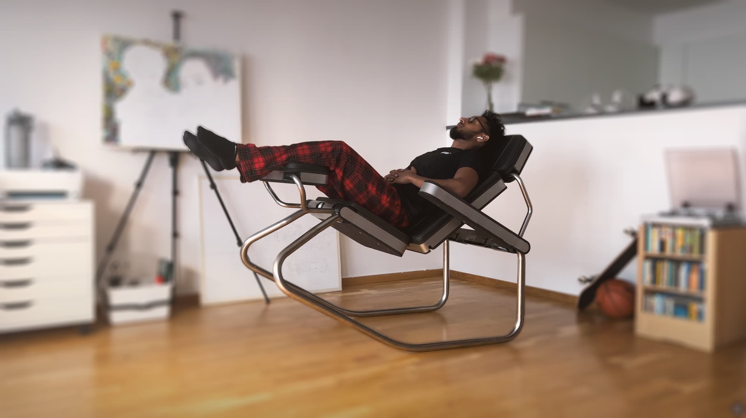 Photo of the same prototype reclined, the man lying back with his feet up